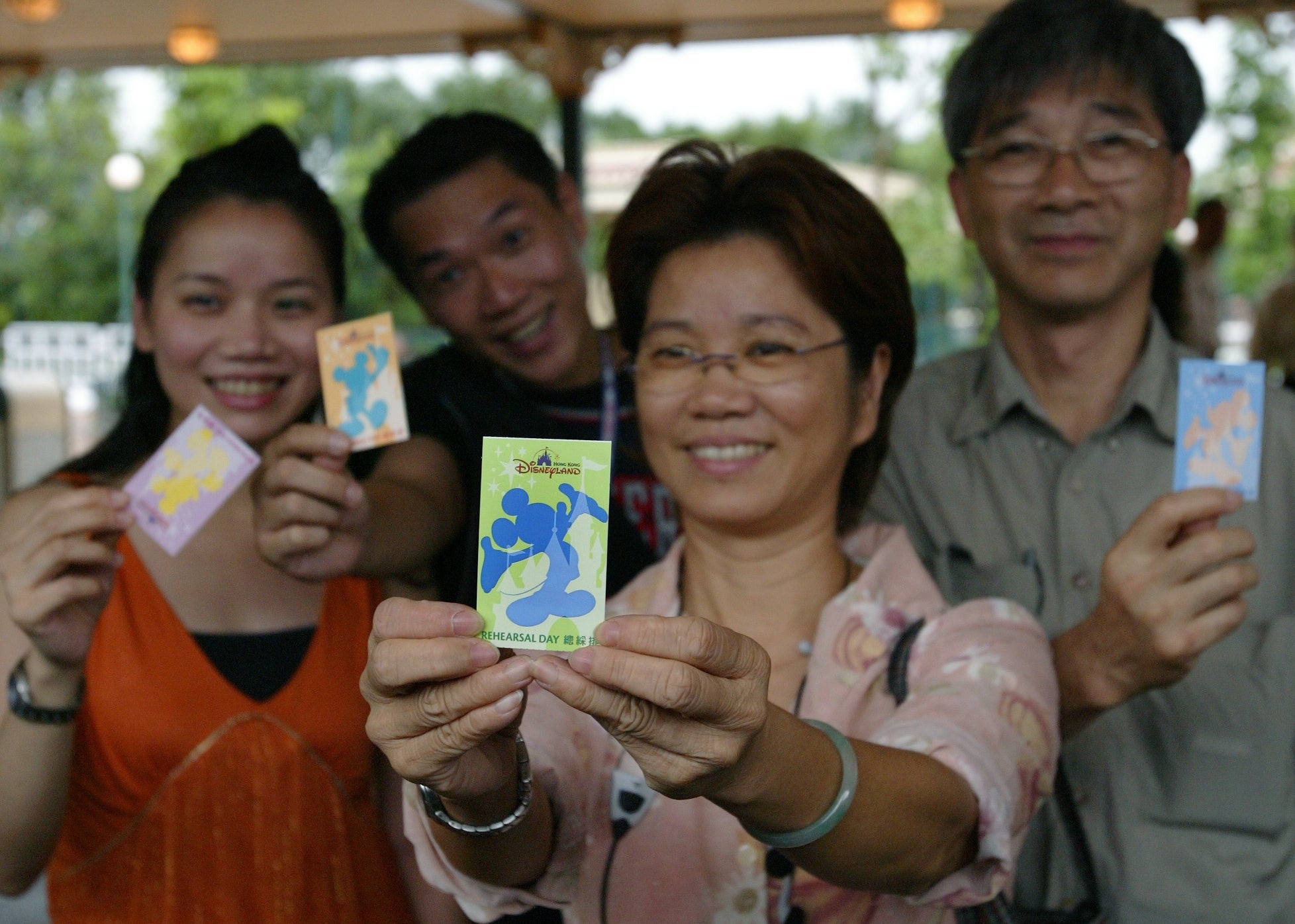 Four radical smiling and holding taxable parkland tickets with cartoon quality designs