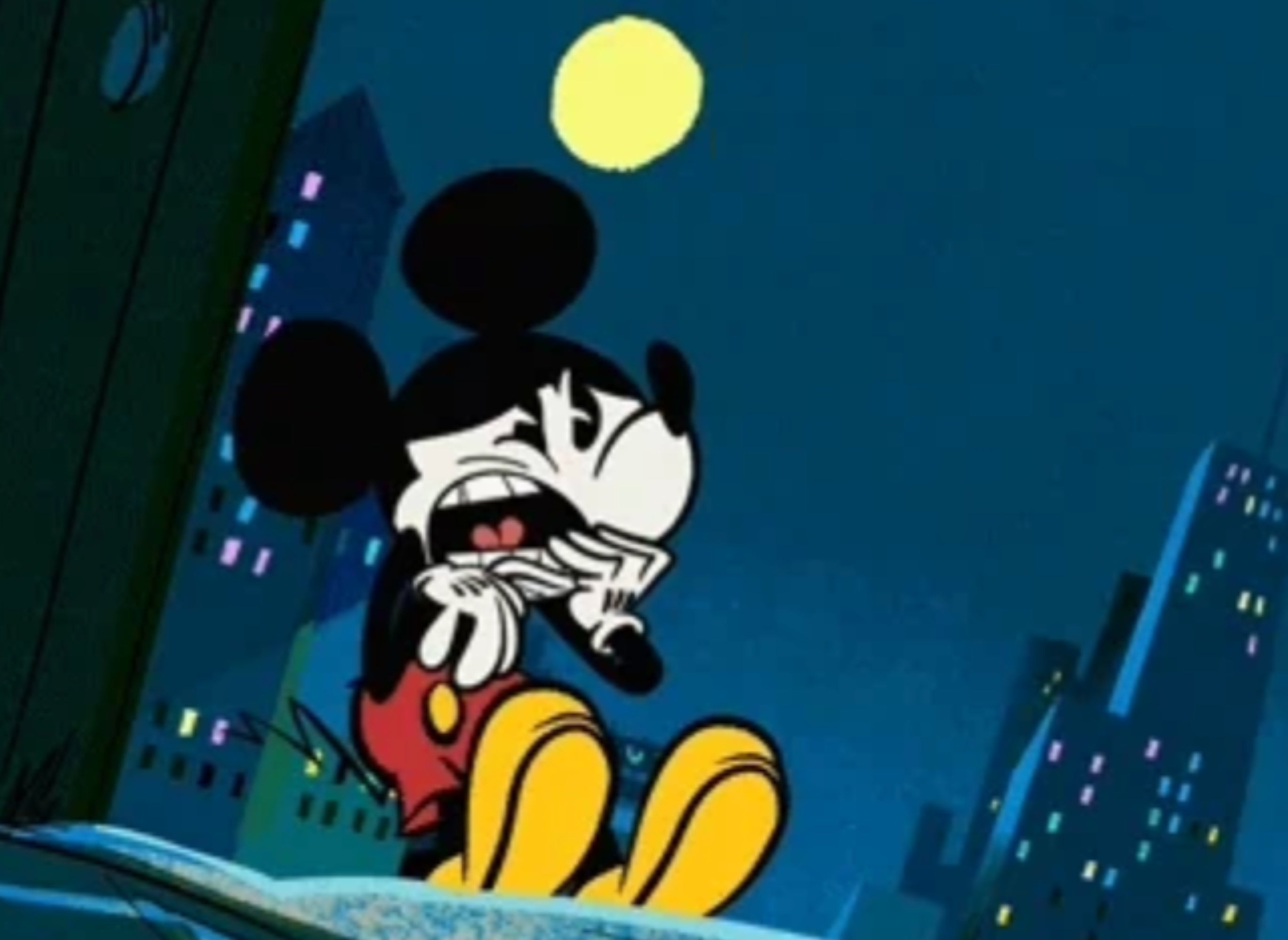 Mickey Mouse is sitting nervously successful an alley astatine night, surrounded by metropolis buildings and a agleam satellite successful the sky