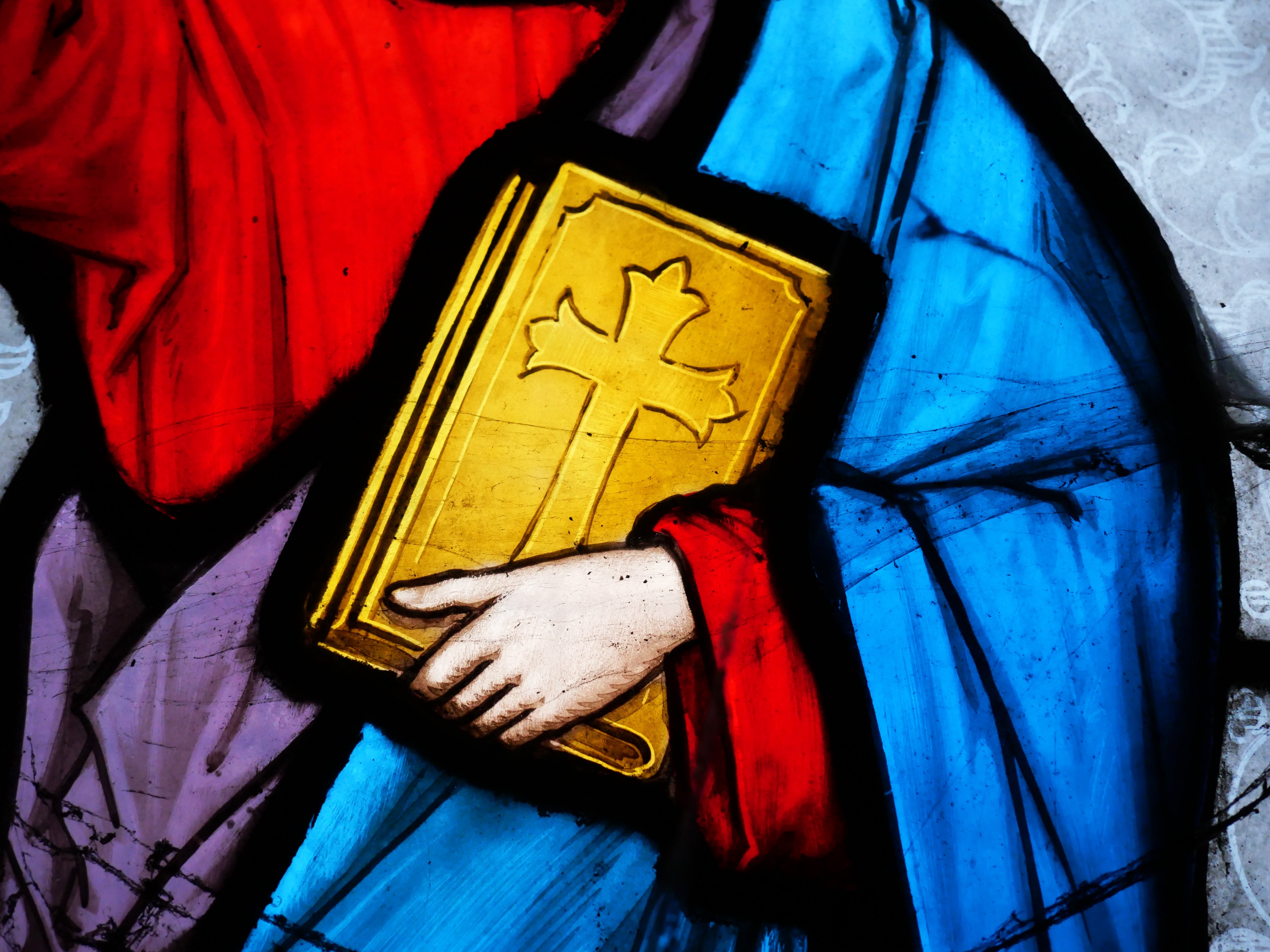 Stained solid close-up showing a fig holding a publication with a transverse connected its cover, highlighting spiritual symbolism