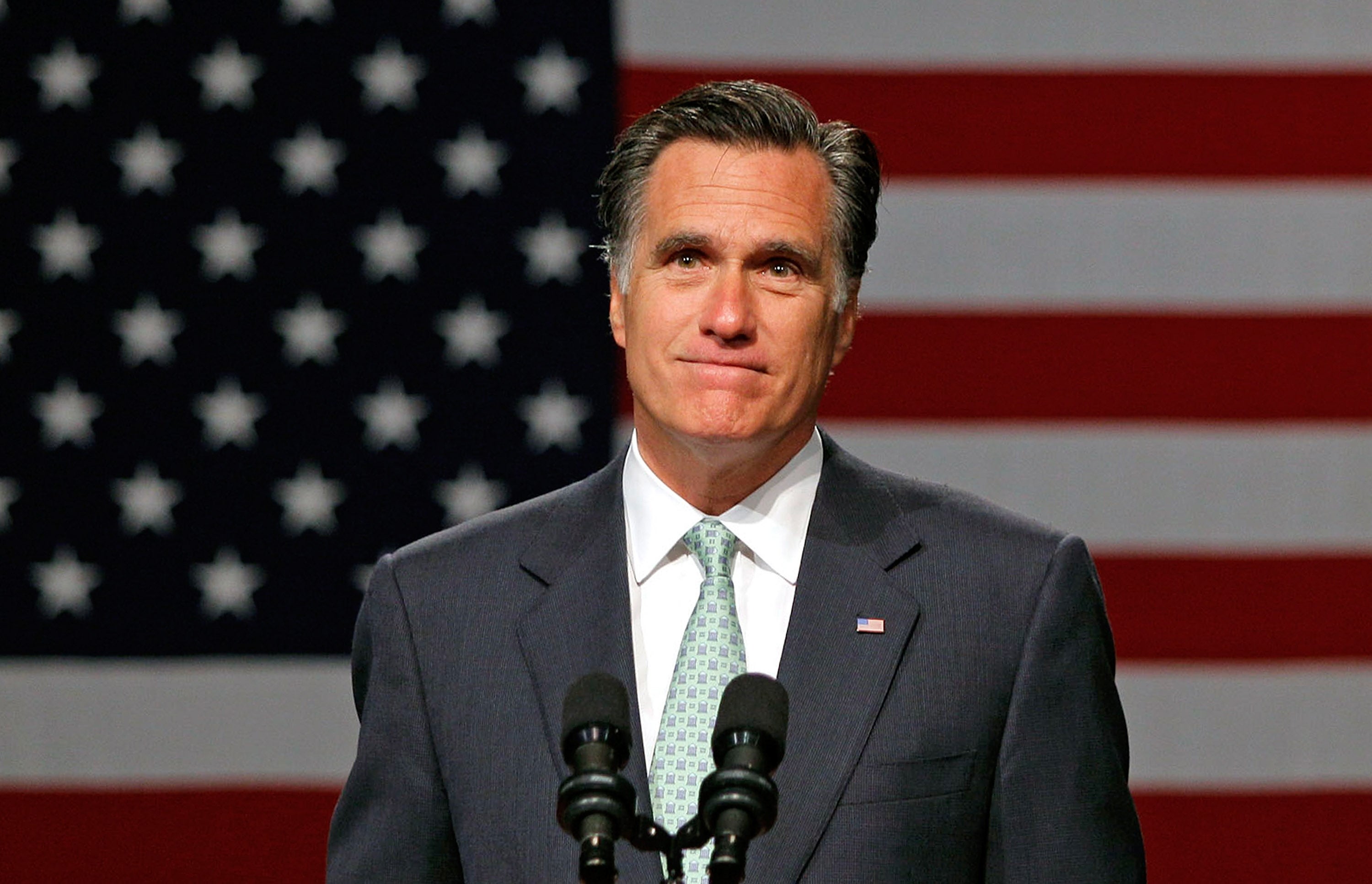 A idiosyncratic successful a suit speaks astatine a podium with a ample American emblem successful the background