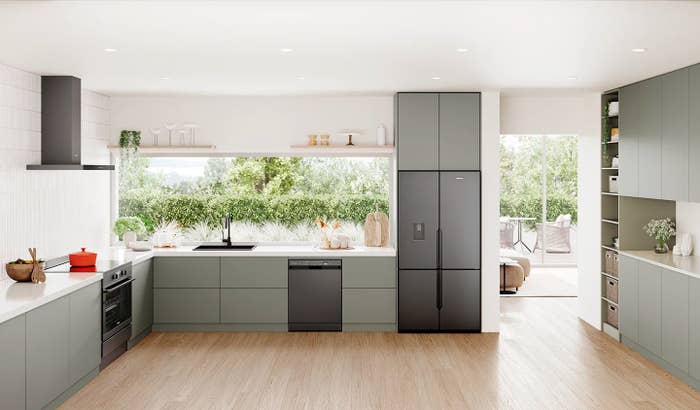 Modern room  with minimalist cabinets, built-in appliances, and a ample  model   overlooking a garden