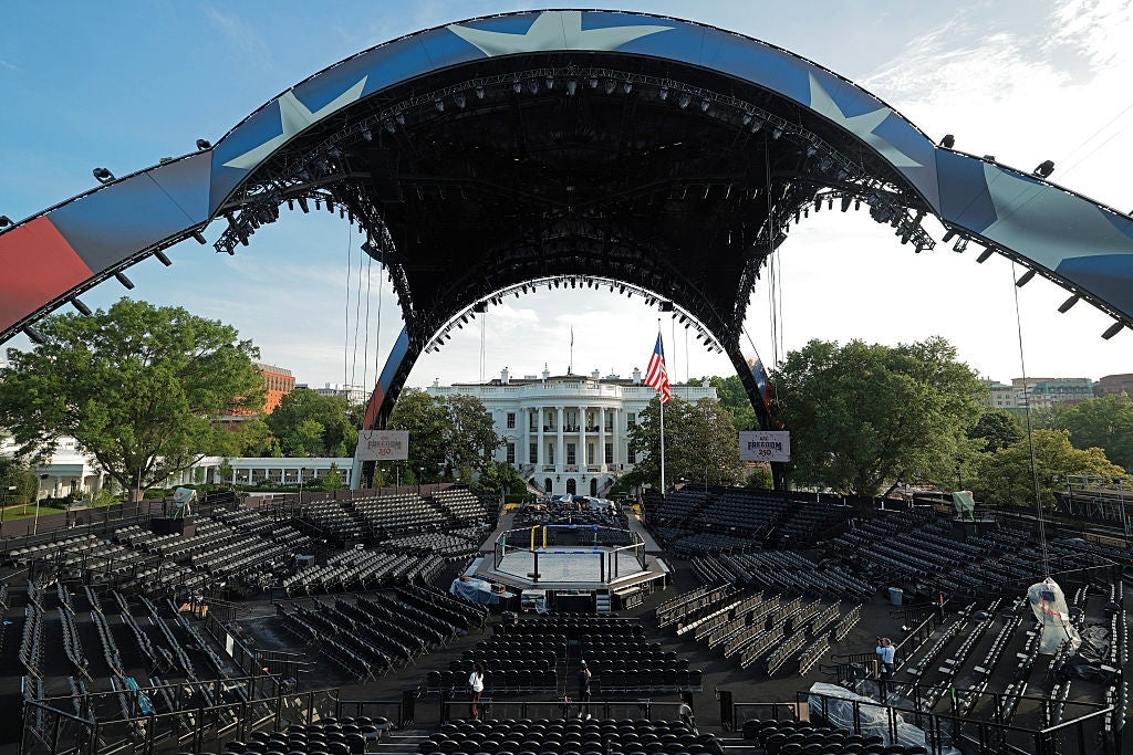 Outdoor venue with seating facing a cardinal  stage, acceptable   against the backdrop of the White House