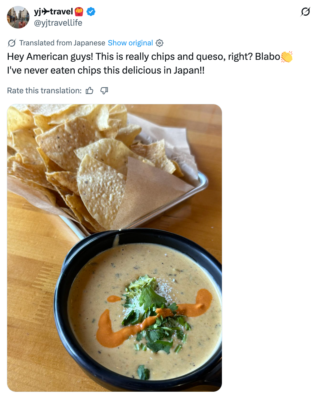 A vessel  of queso topped with garnish adjacent  to a handbasket  of tortilla chips, tweeted with excitement astir  trying them successful  America