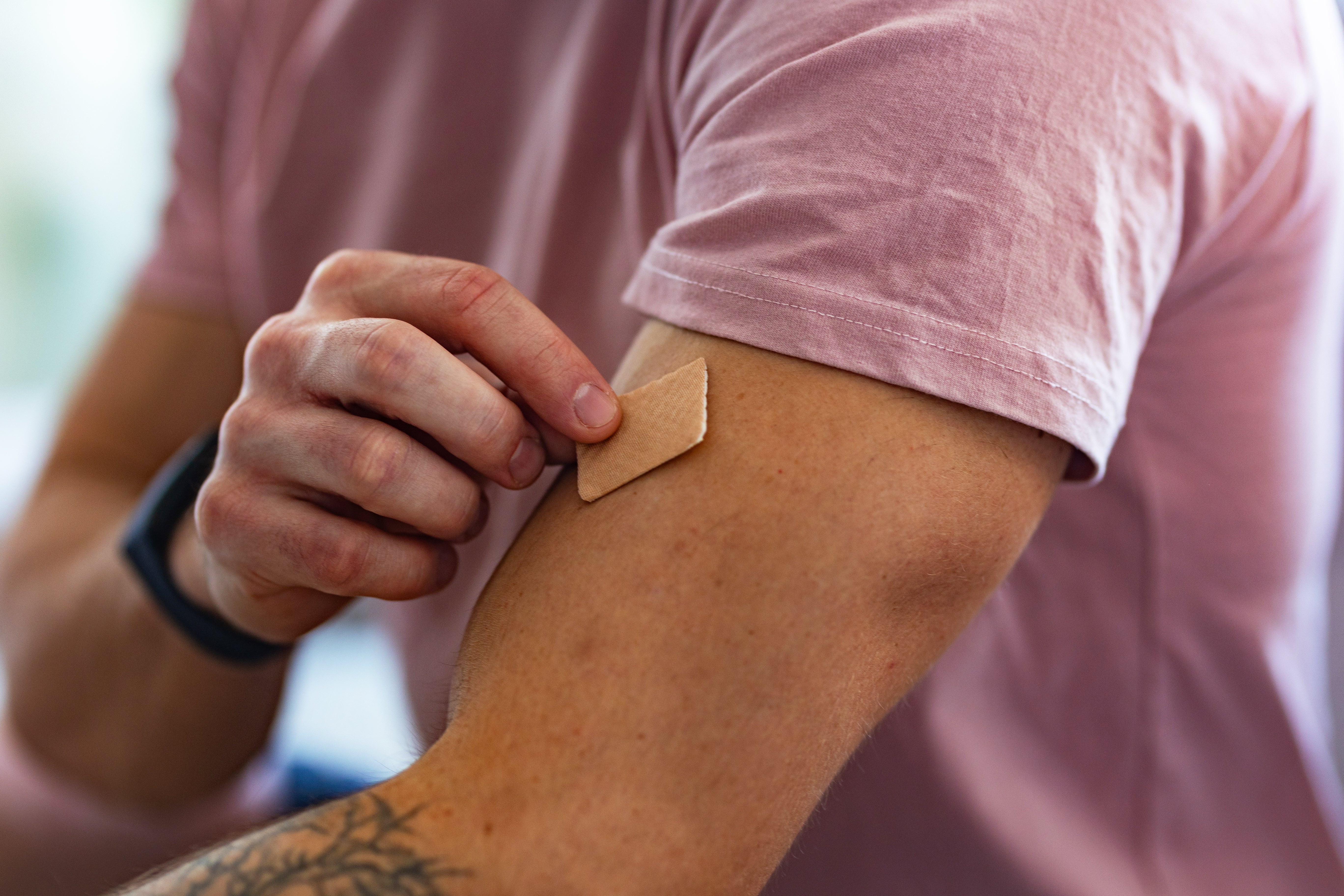 Person applying a quadrate spot to their precocious arm