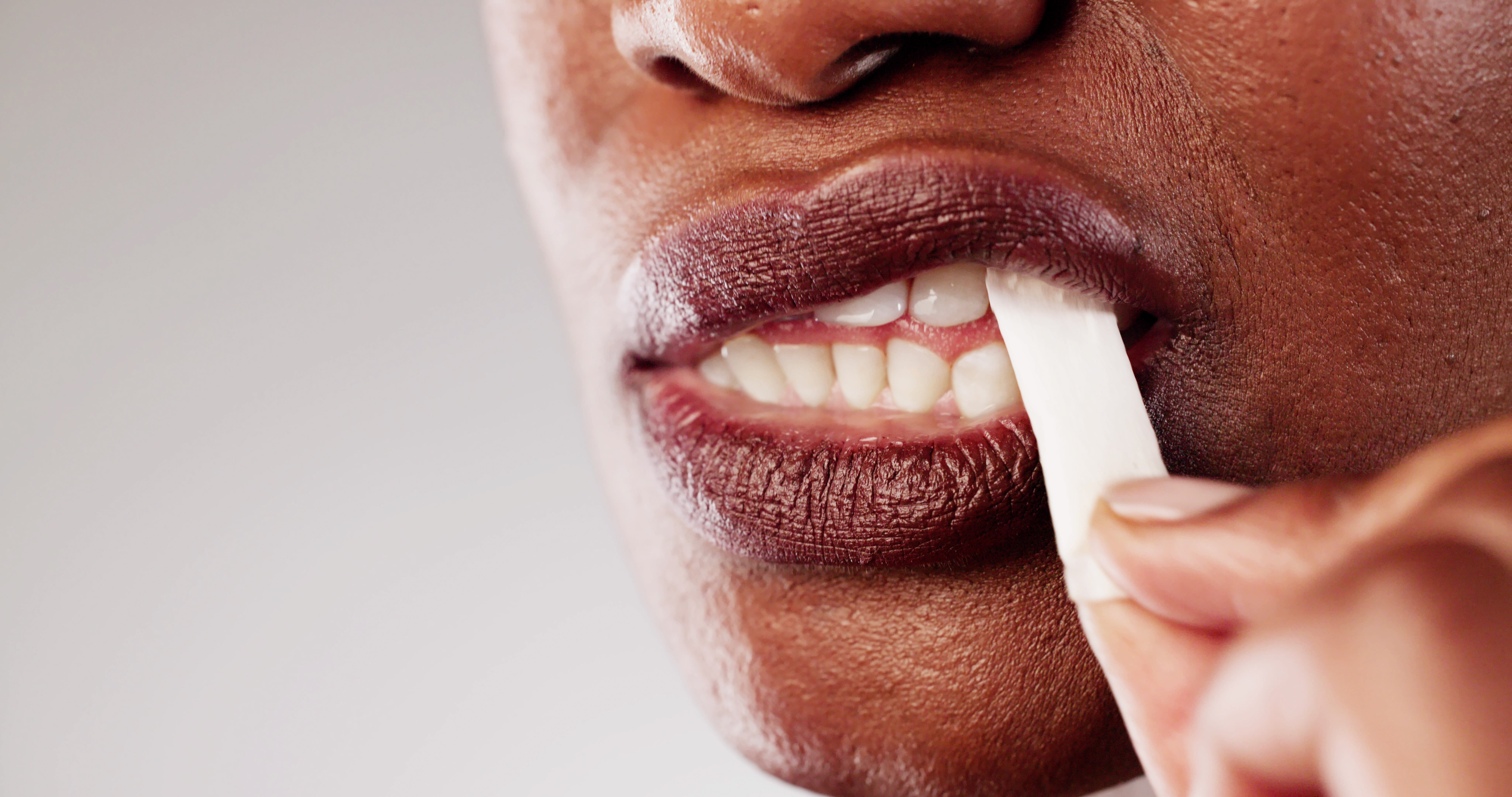 Person astir to chew a instrumentality of gum, partially disposable look and hand