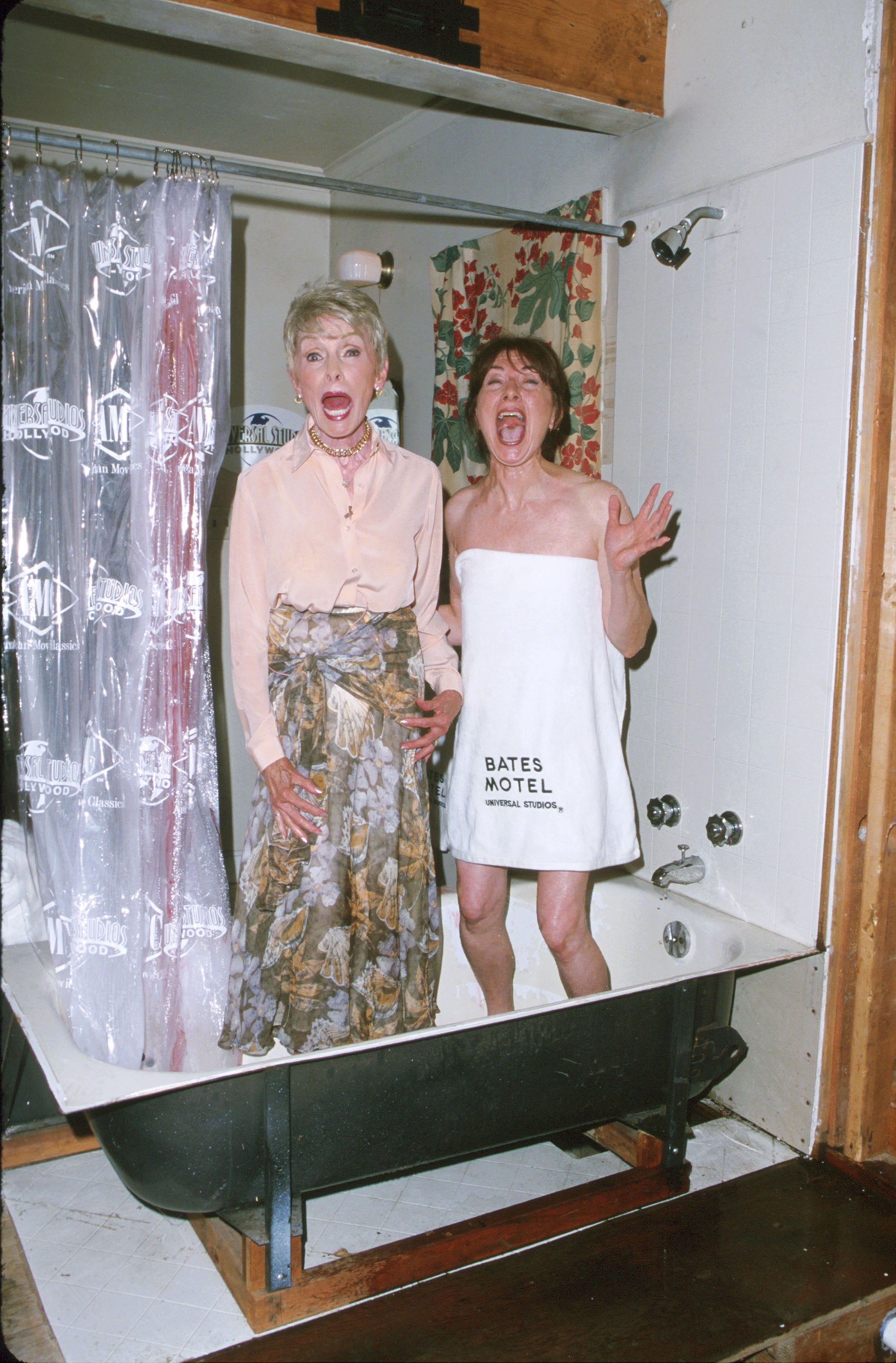 Two radical   basal   successful  a bathtub, 1  successful  a floral skirt and blouse, the different   wrapped successful  a "Bates Motel" towel, some  expressing alarm