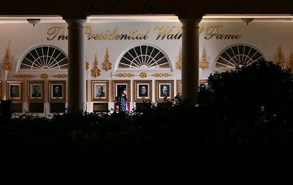 Night presumption of a gathering with the "Presidential Walk of Fame." Portraits are displayed nether lit arches and columns