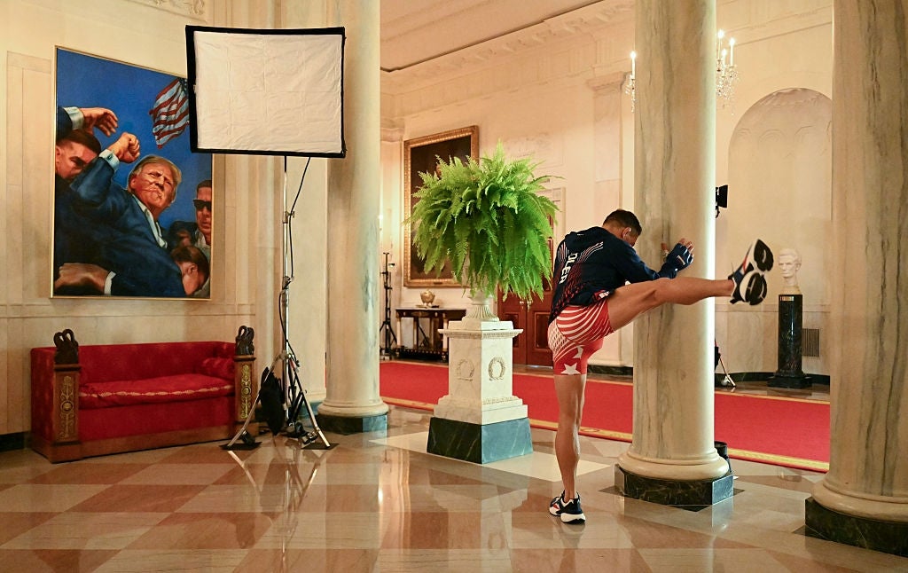 Person stretching successful an elegant country with a ample coating and lighting instrumentality visible