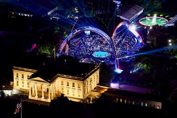 Aerial presumption    of a nighttime  lawsuit   with a ample  assemblage  nether  illuminated arches adjacent   a salient  building