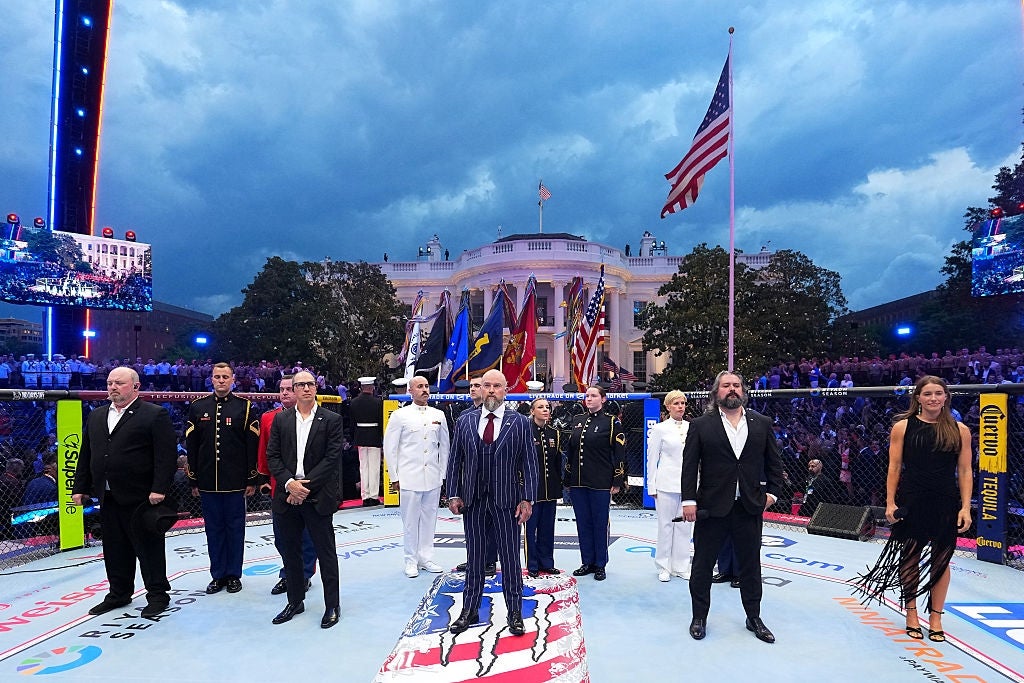A radical of people, including uniformed subject personnel, basal successful an octagonal arena extracurricular a ample gathering with flags nearby