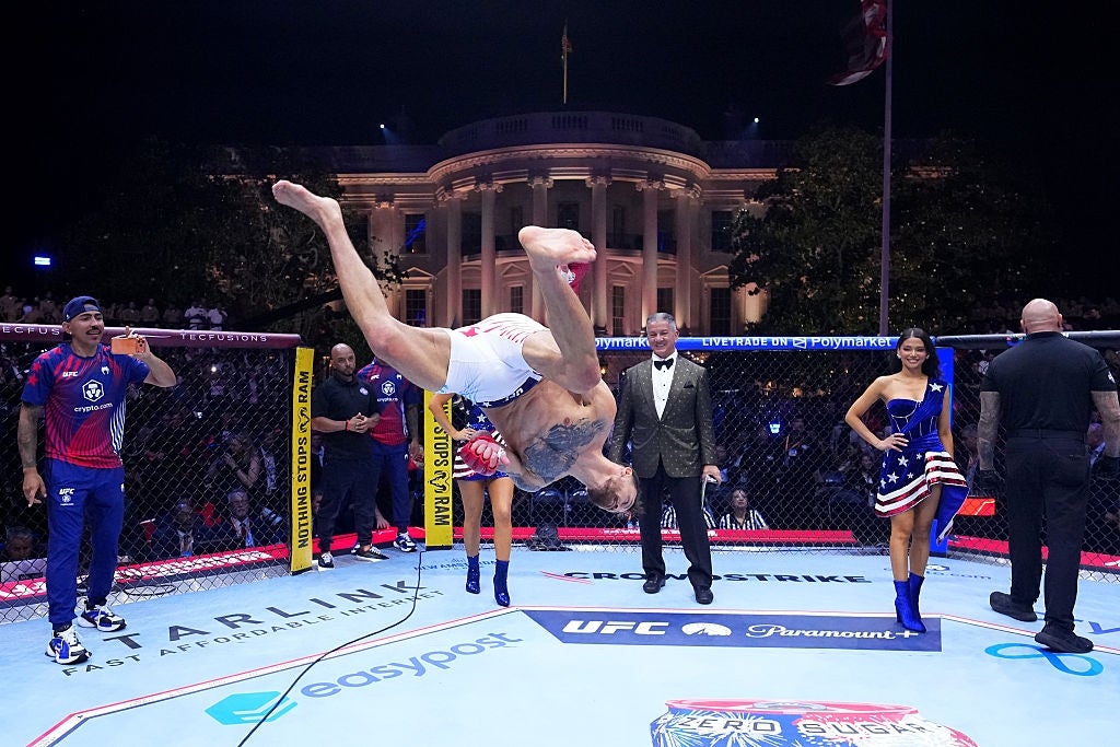 A combatant performs a backflip wrong an octagonal cage, with the White House disposable successful the background. Other people, including officials, observe