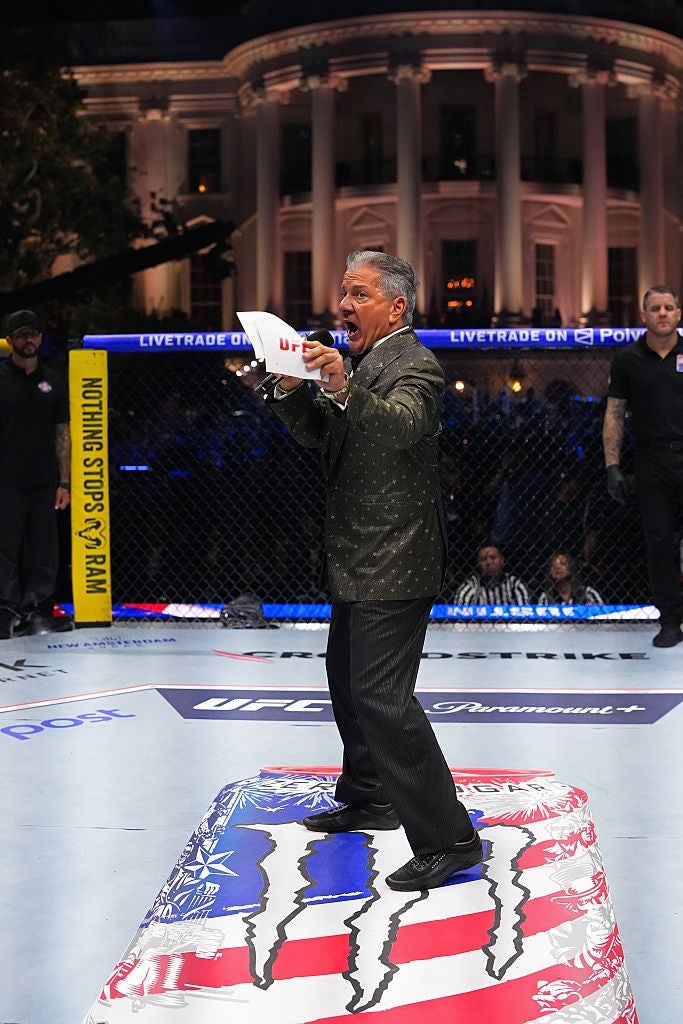 Ring announcer successful a patterned suit energetically announces astatine a UFC event, lasting connected a level printed with the American flag