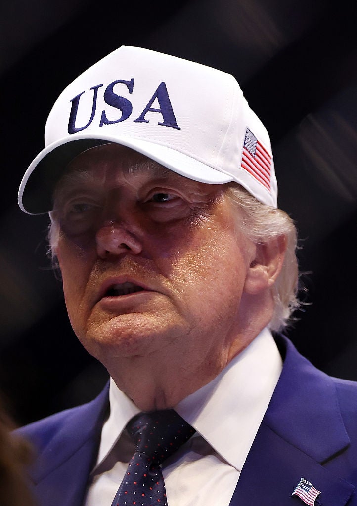 Person wearing a "USA" headdress and suit with an American emblem pin