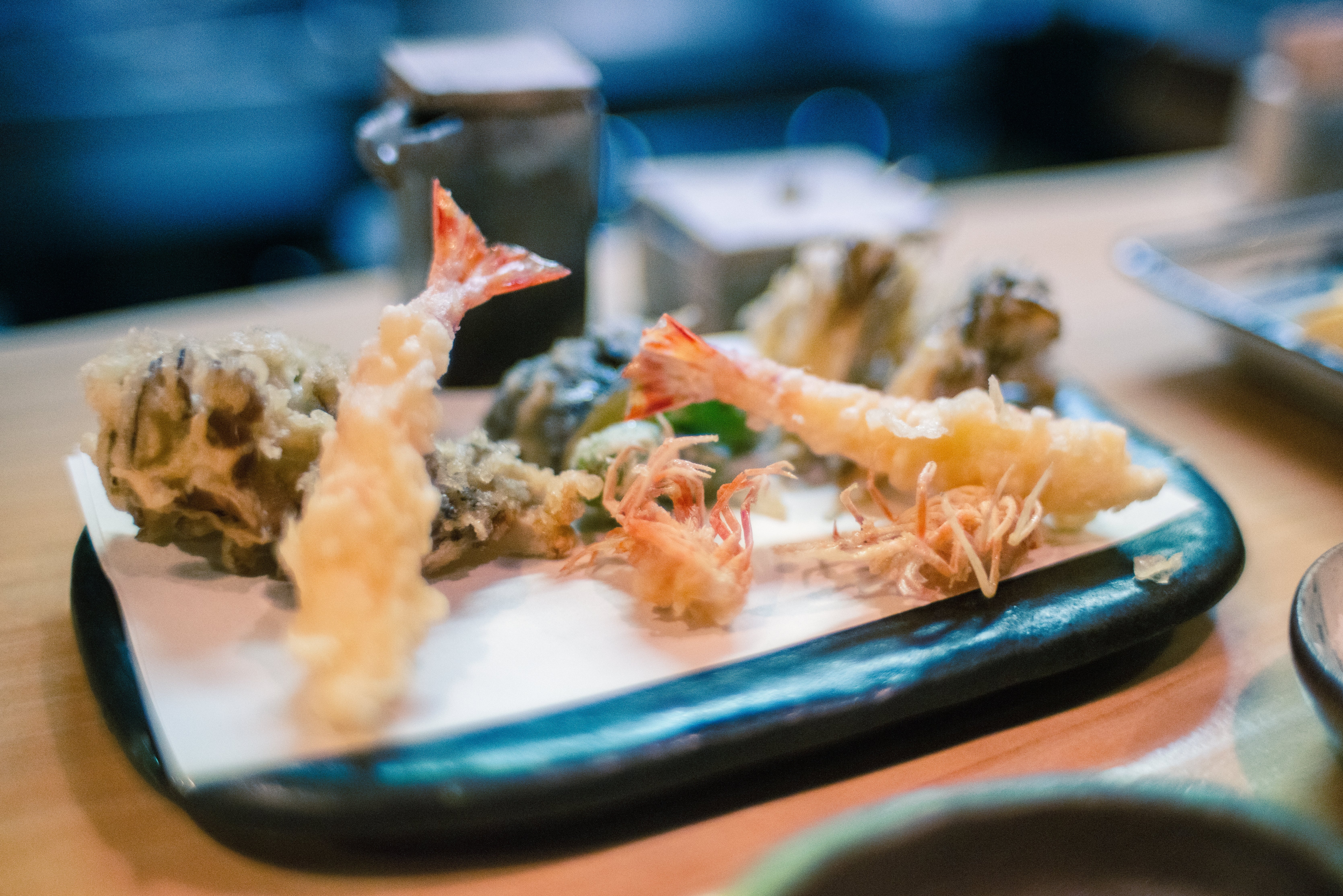 A assortment of tempura dishes, including shrimp and vegetables, served connected a tray astatine a restaurant