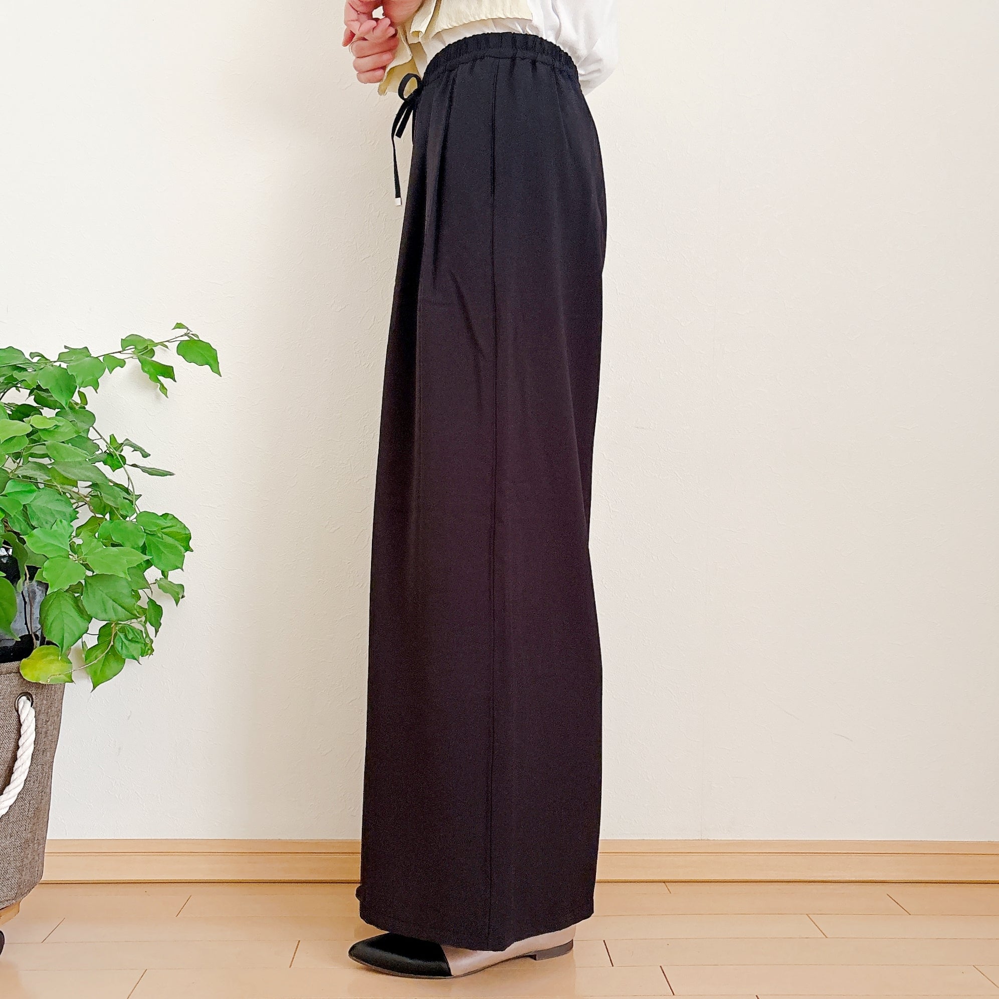GU（ジーユー）の「ドレープワイドパンツ（丈標準66.0～70.0cm）」身長162cm女性でSサイズを着用。横向きに立っている様子。