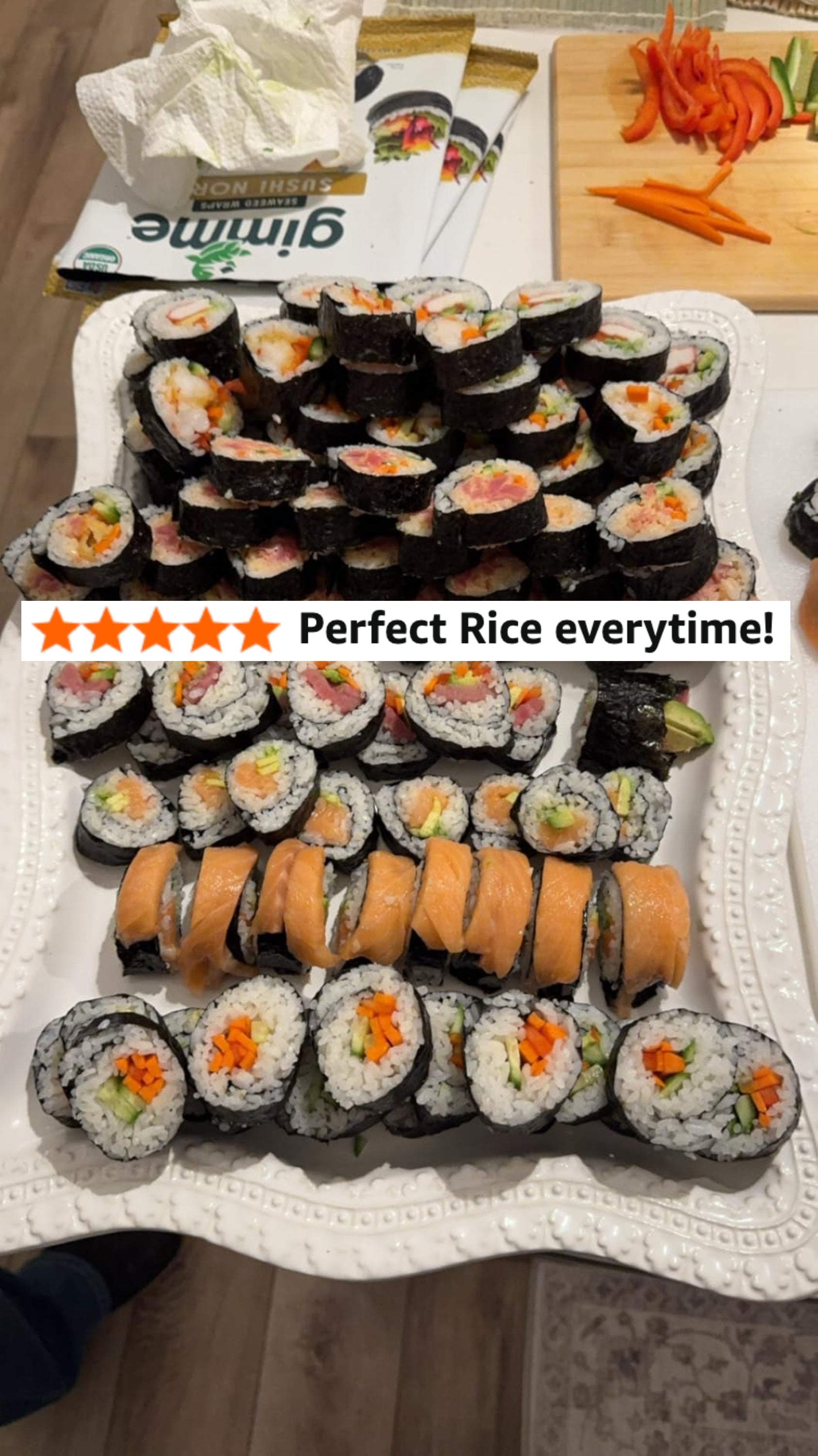 A platter of assorted sushi rolls includes seaweed-wrapped rolls with food  and vegetables, and rice-wrapped rolls with salmon connected  top