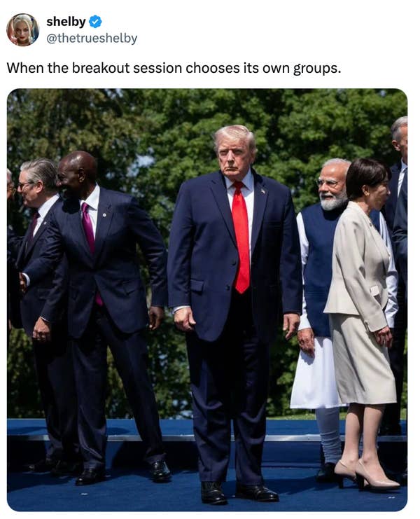People in formal attire awkwardly spaced apart outdoors, resembling a candid group moment