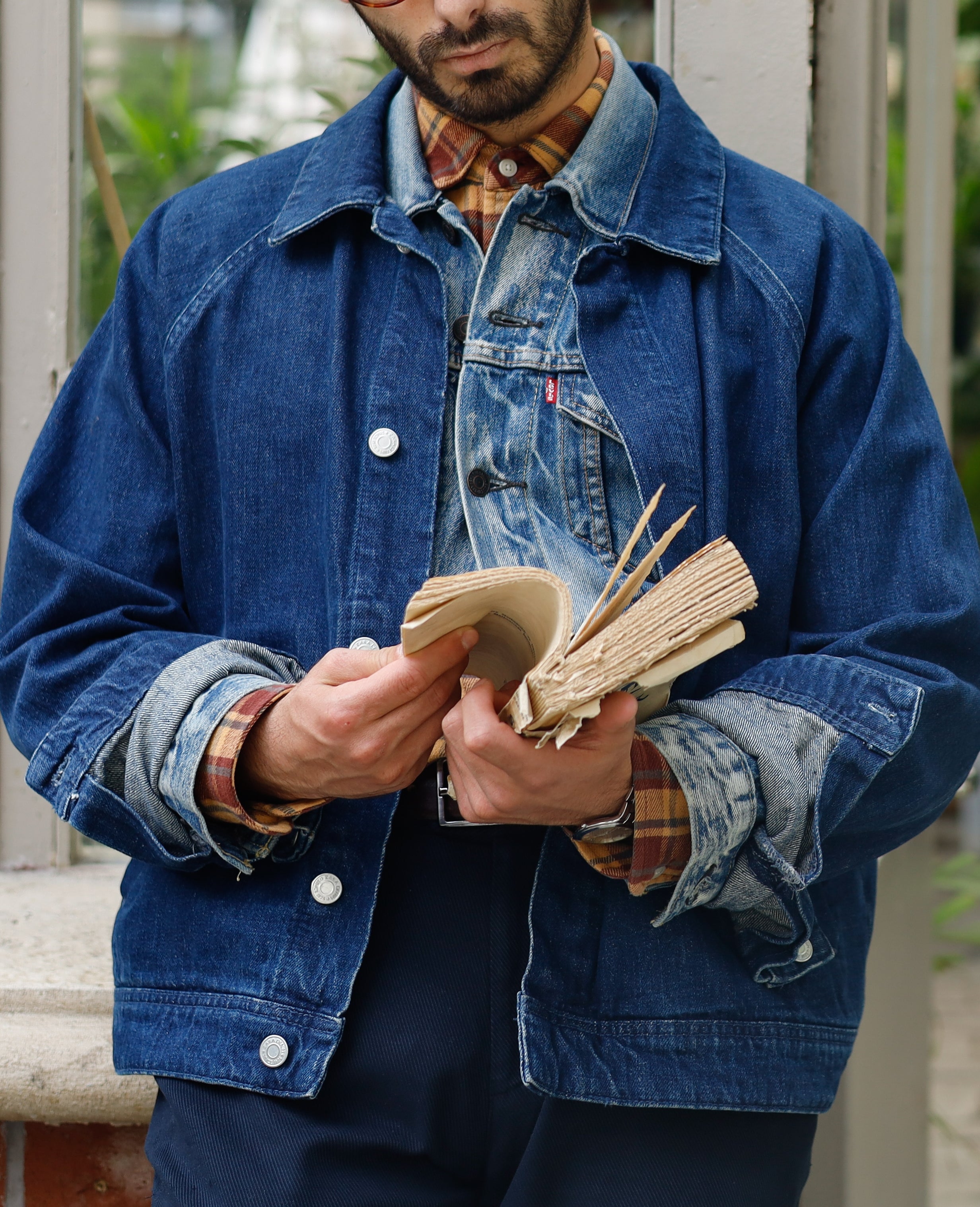 Person wearing layered denim outfits speechmaking a publication successful a plot setting