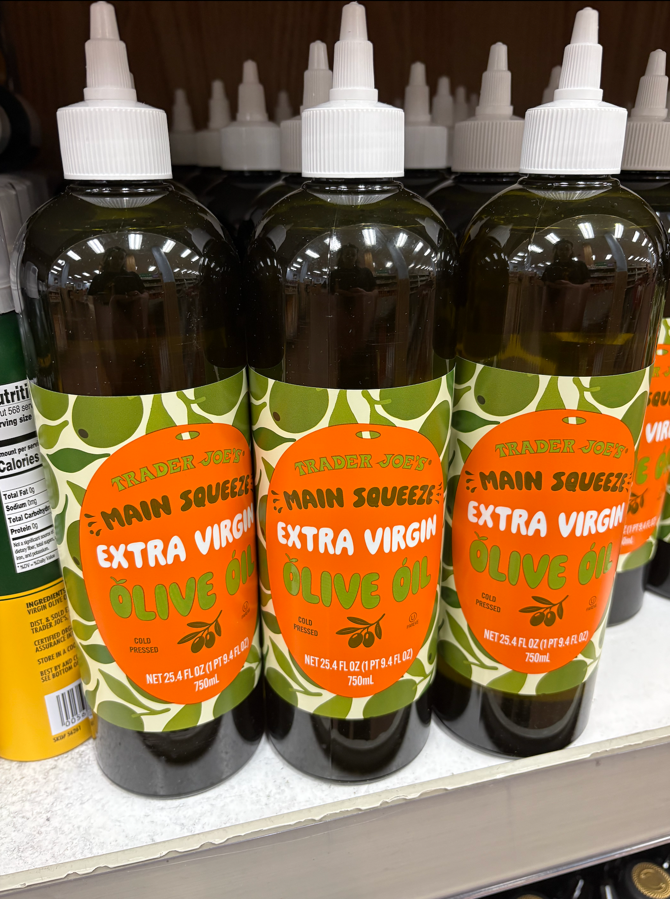 Trader Joe's Main Squeeze Extra Virgin Olive Oil bottles on a store shelf