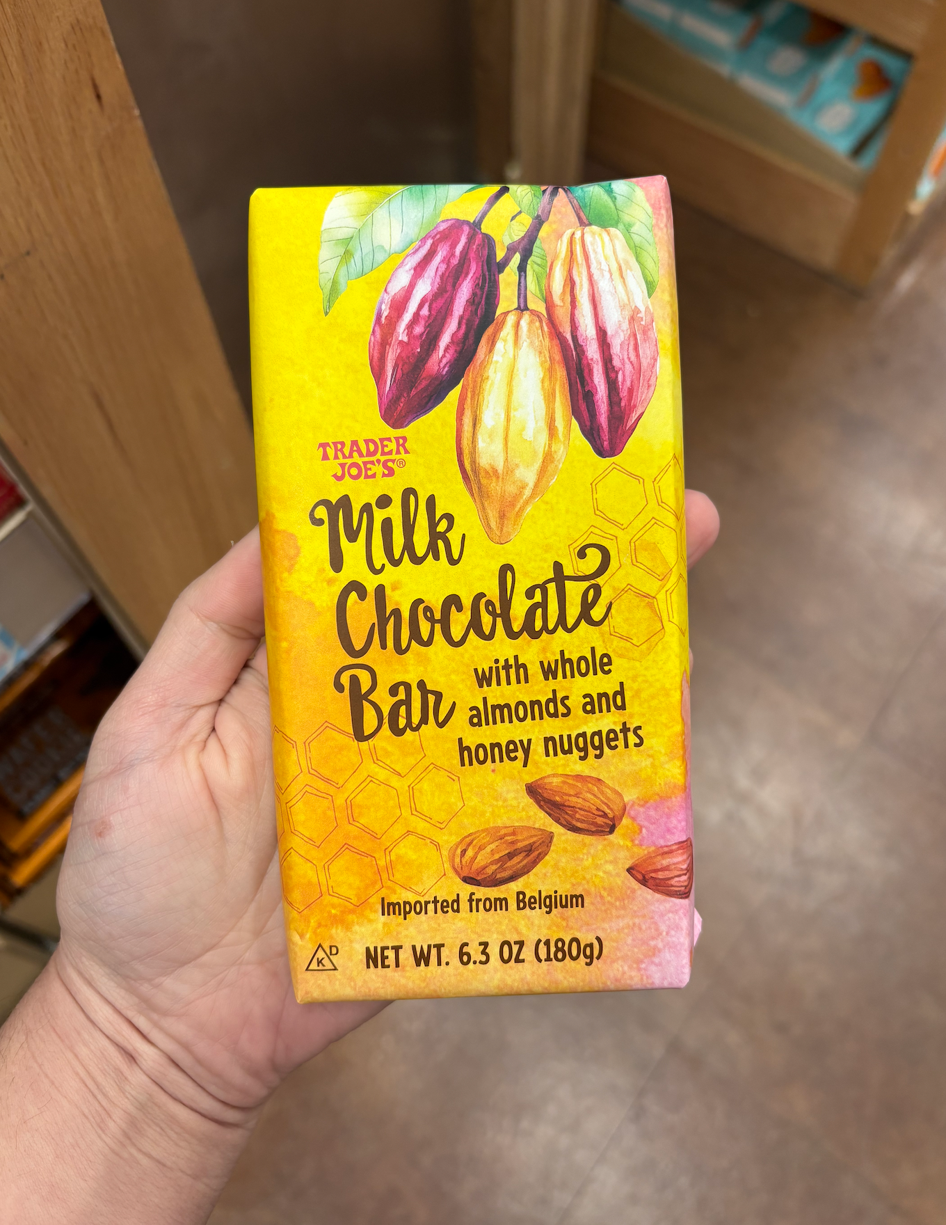 Milk chocolate bar packaging with whole almonds and honey nuggets design, 6.3 oz, imported from Belgium