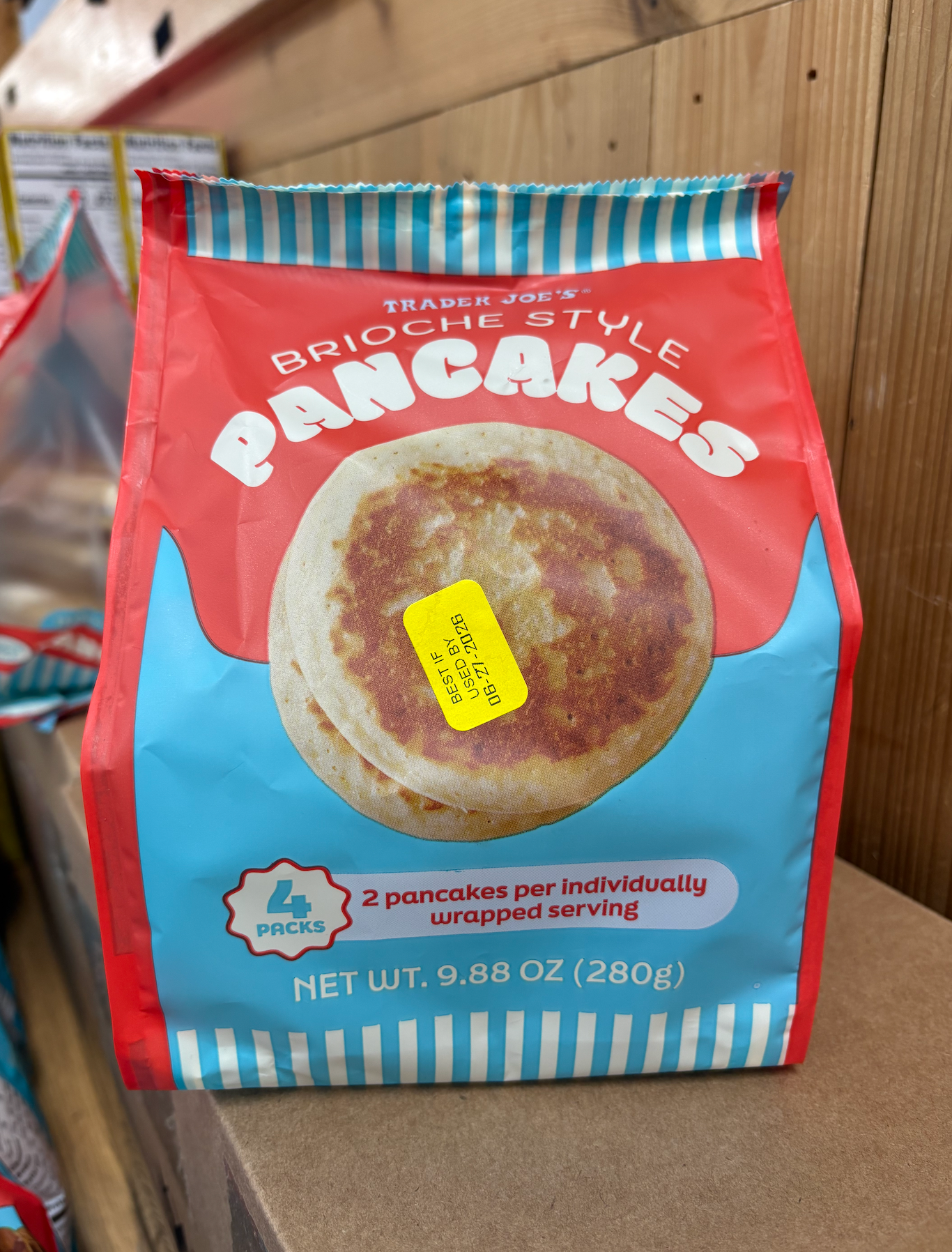 Trader Joe's brioche-style pancakes package, showing 4 packs of 2 pancakes each, with a price sticker on the front