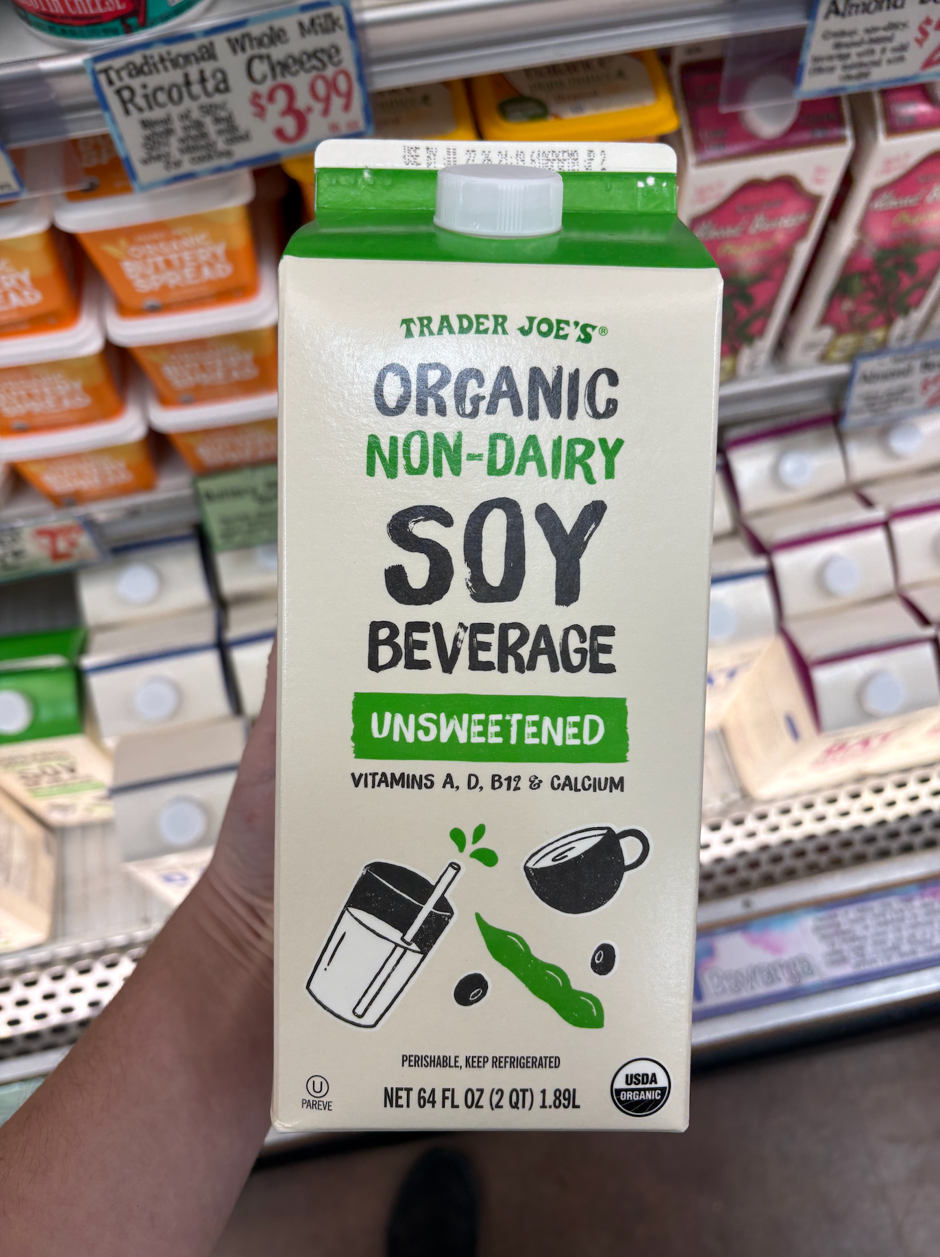 A carton of Trader Joe's Organic Non-Dairy Soy Beverage, unsweetened, with vitamins A, D, B12, calcium, and USDA organic certification