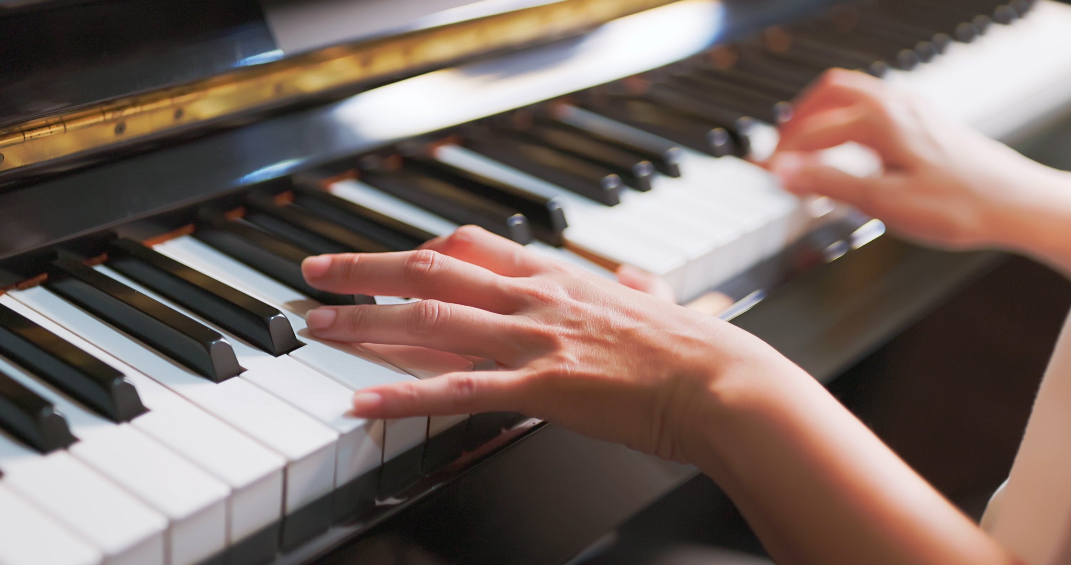 Hands playing a soft keyboard, focusing connected the fingers pressing the keys