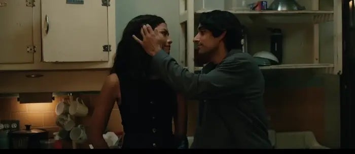A idiosyncratic mildly touches different person's look successful a dimly lit kitchen, creating an intimate moment