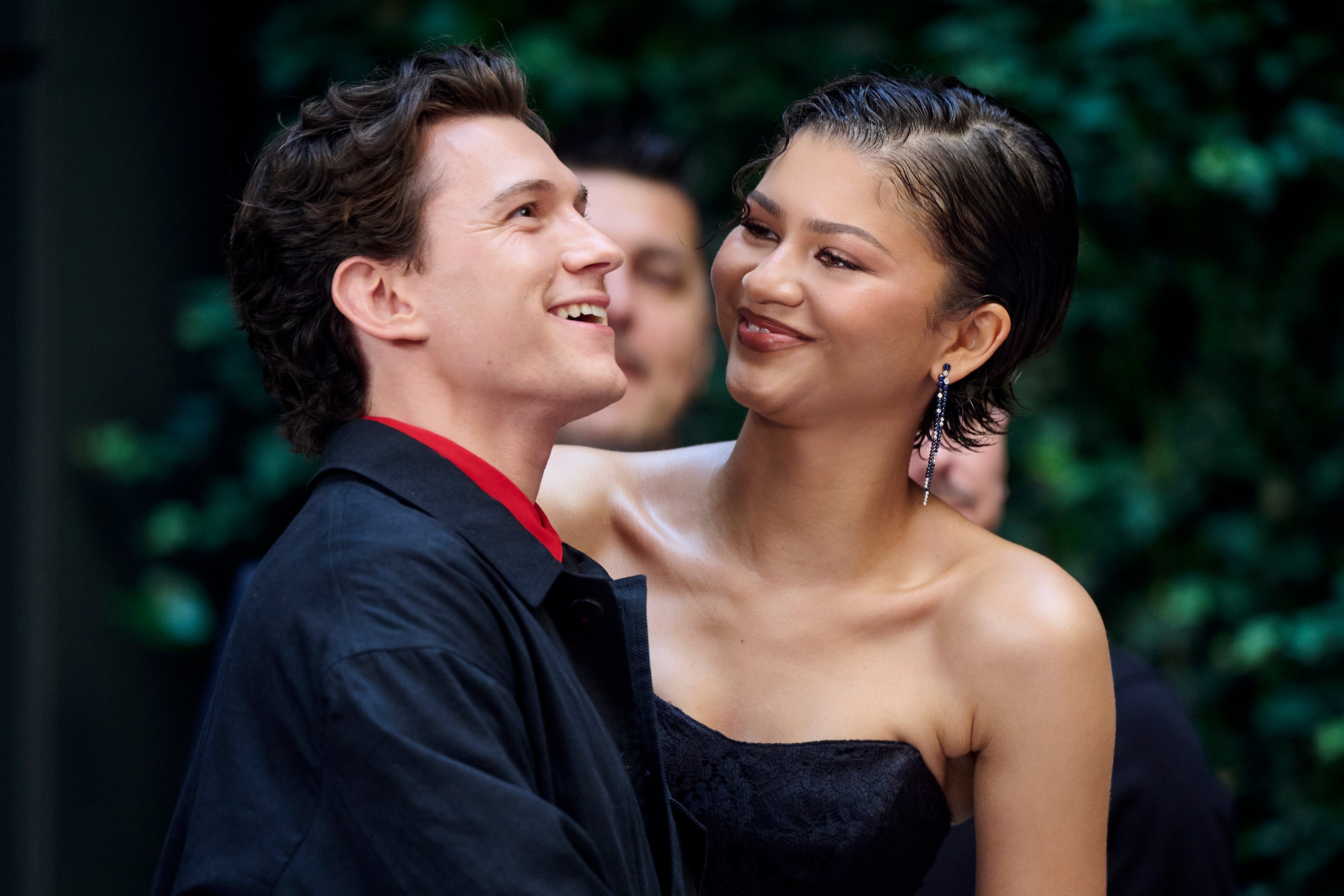 Two individuals smiling astatine each other; the pistillate wears a strapless dress, and the antheral is successful a casual overgarment with a collared shirt
