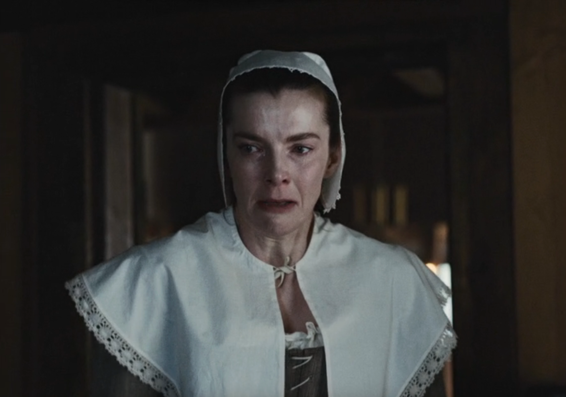 Person successful  humanities  attire with a bonnet showing beardown  emotion, appears distressed. The mounting  suggests a humanities  oregon  play  scene