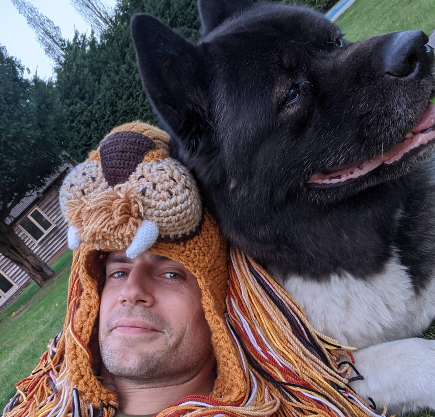 Henry Cavill taking a selfie with his dog while wearing a crochet lion hat
