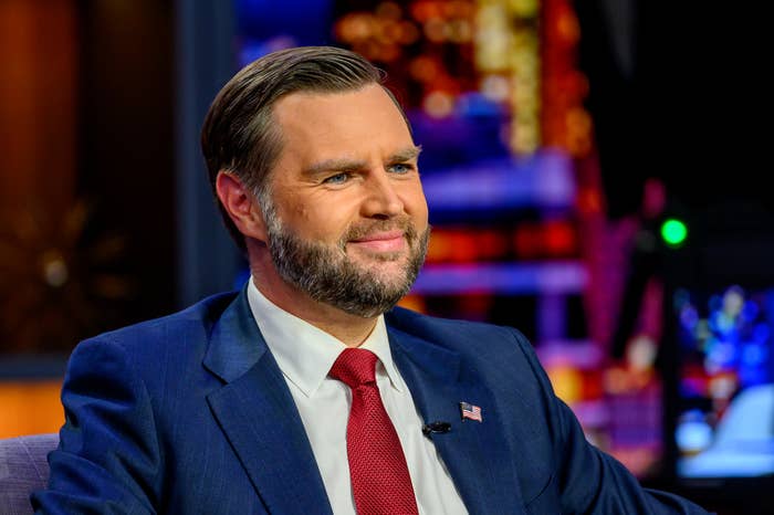 Person successful  a suit   and necktie  seated connected  a speech   amusement   acceptable   with cityscape backdrop