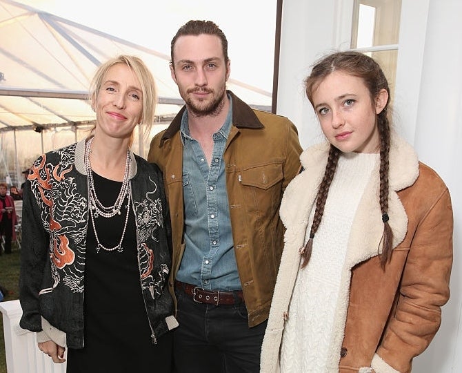 Three radical lasting together, smiling. The idiosyncratic connected the near wears a patterned blazer, the mediate idiosyncratic wears a casual jacket, and the 3rd has a sherpa coat