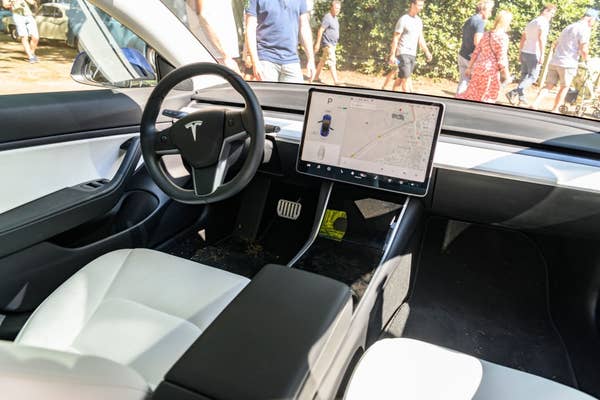 Interior of a Tesla with a large touchscreen display showing maps