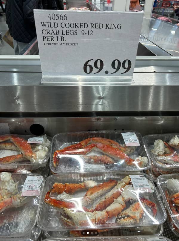 Packages of wild cooked red king crab legs displayed for sale, priced at $69.99 per pound
