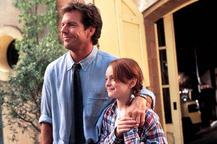 Two radical   lasting  extracurricular  a building. The antheral   wears a collared garment  and tie; the young idiosyncratic   wears a plaid shirt, smiling and looking ahead