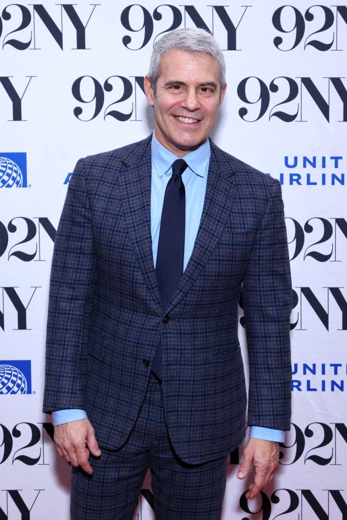 Man successful  a plaid suit   and bluish  garment  poses astatine  a 92NY lawsuit   backdrop