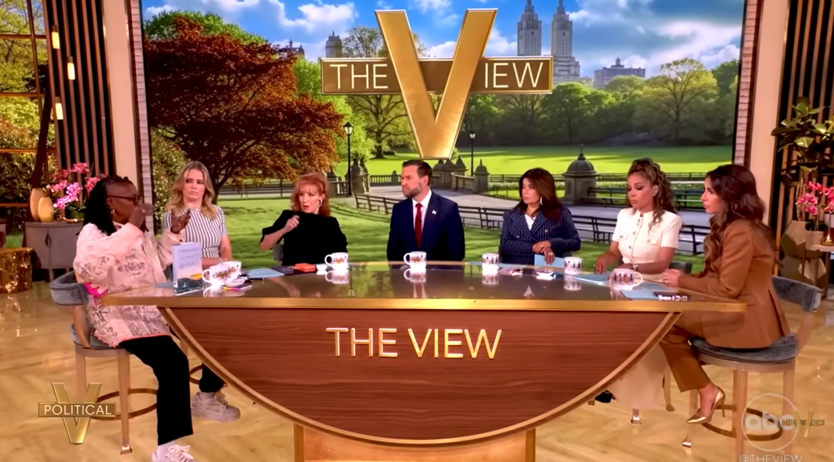 TV talk show panel discusses current events; hosts seated at a round table with NYC skyline backdrop