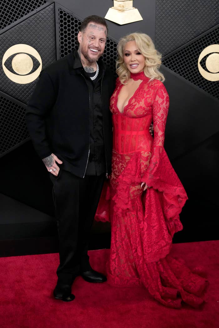 Bunnie Xo successful  an elegant lace gown and Jelly Roll successful  a suit   with tattoos disposable   connected  the reddish  carpet