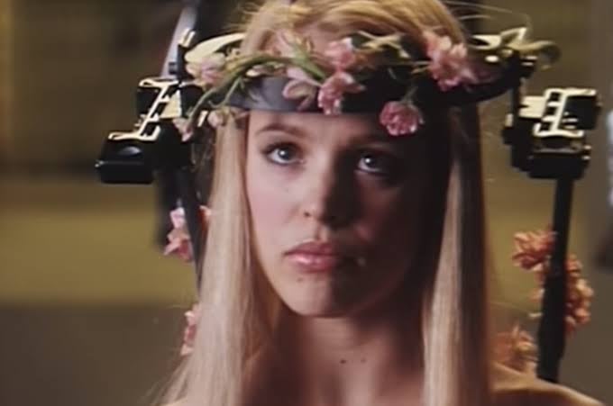 A idiosyncratic   wearing a aesculapian  halo headgear adorned with pinkish  flowers, conveying a premix  of vulnerability and resilience