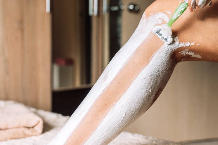 A idiosyncratic   shaving their limb  with a razor, shaving pick  is rubbed in