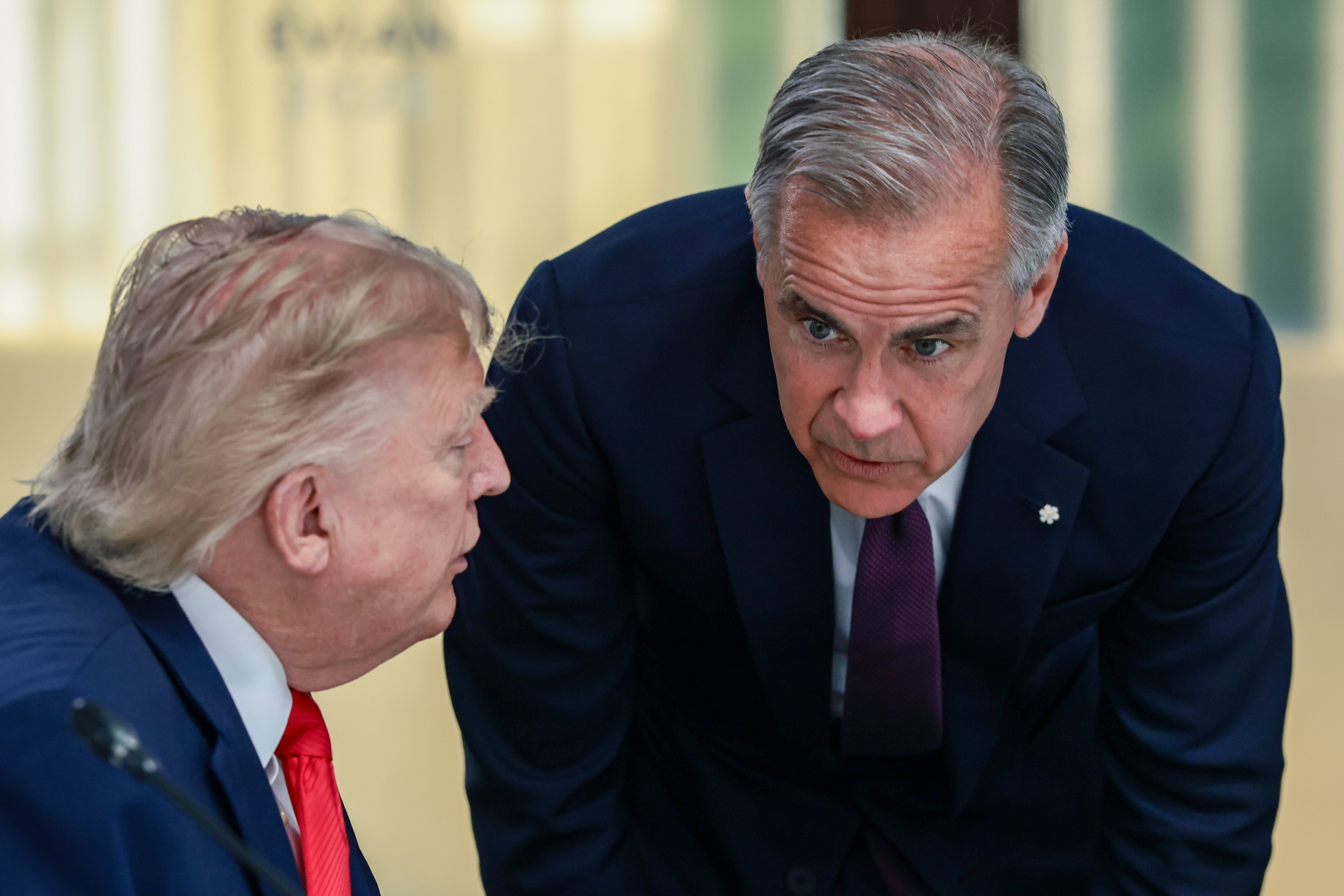 Two men successful suits are engaged successful a superior speech indoors