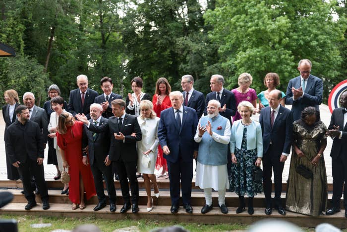 Group of nationalist   figures lasting  outdoors, assorted  styles of ceremonial  attire