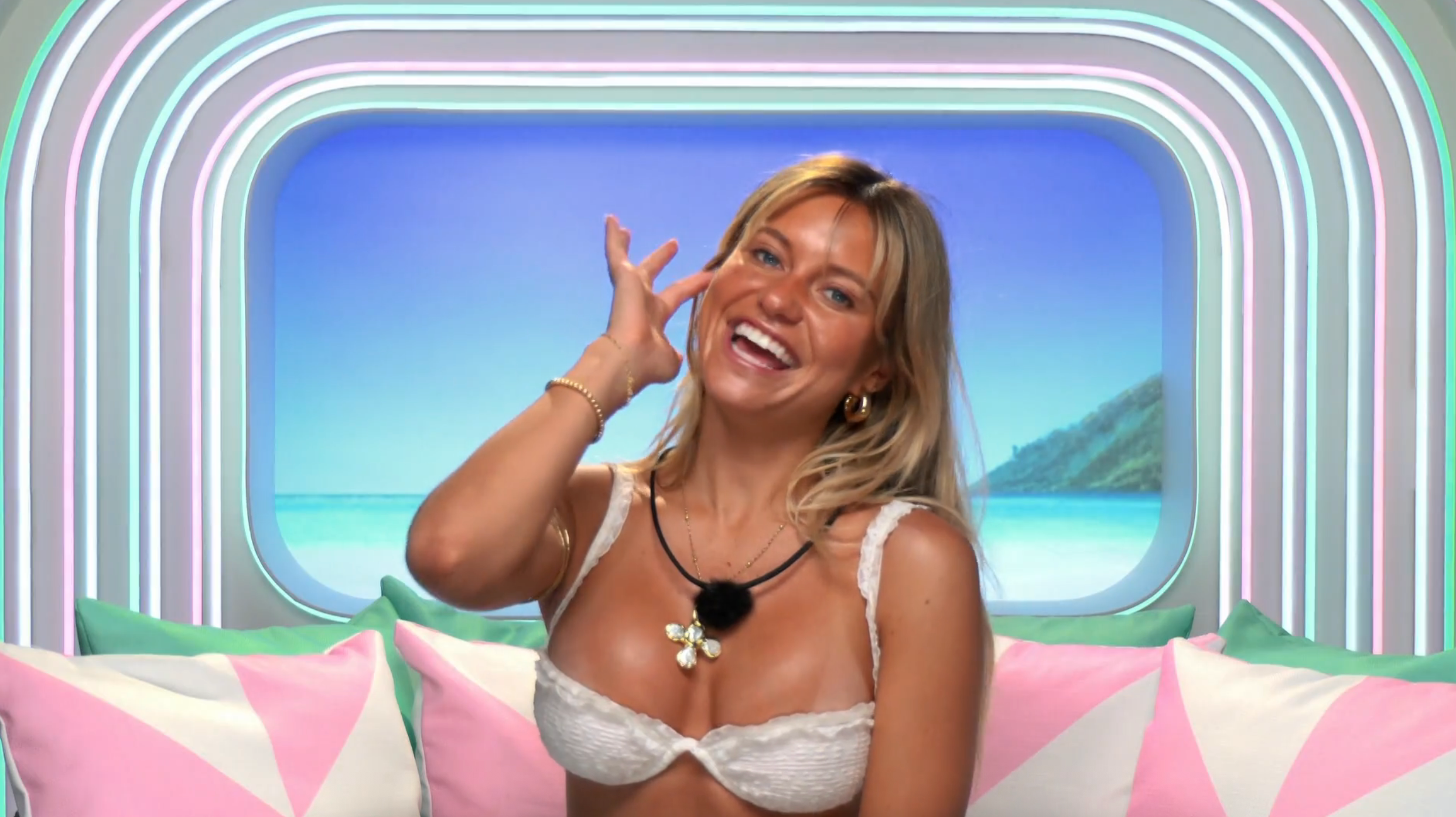 Person successful a bikini smiling and posing playfully successful a tropical-themed room