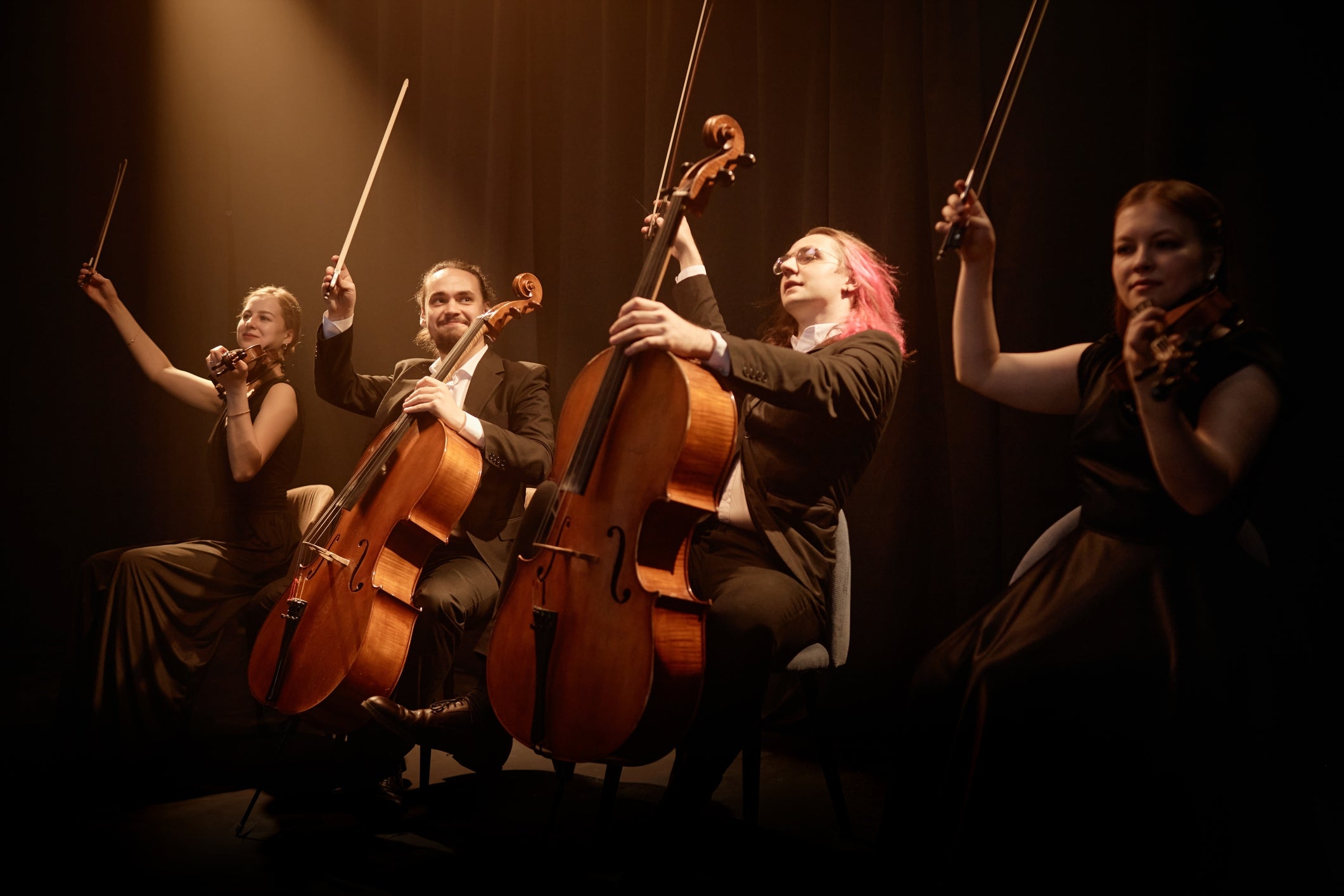 A drawstring quartet performs passionately connected stage, each instrumentalist profoundly focused connected playing their instruments