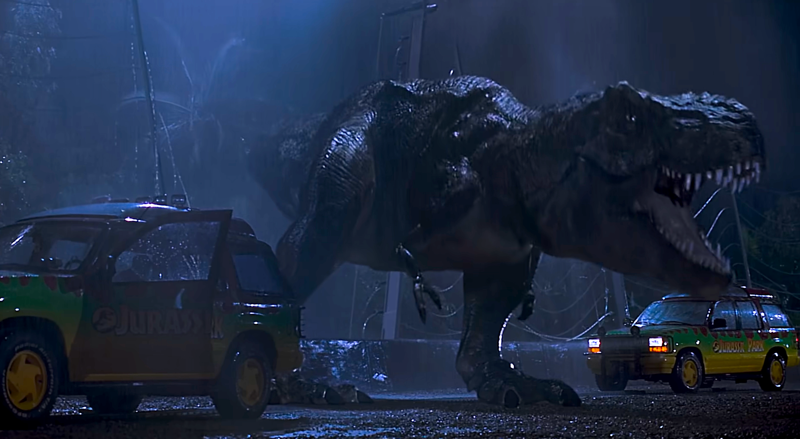 A T-Rex roars successful  betwixt  2  cars