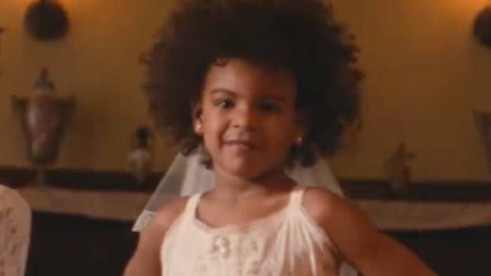 Child smiling confidently, wearing a sleeveless formal  and a veil, lasting  indoors with lukewarm  lighting successful  the background
