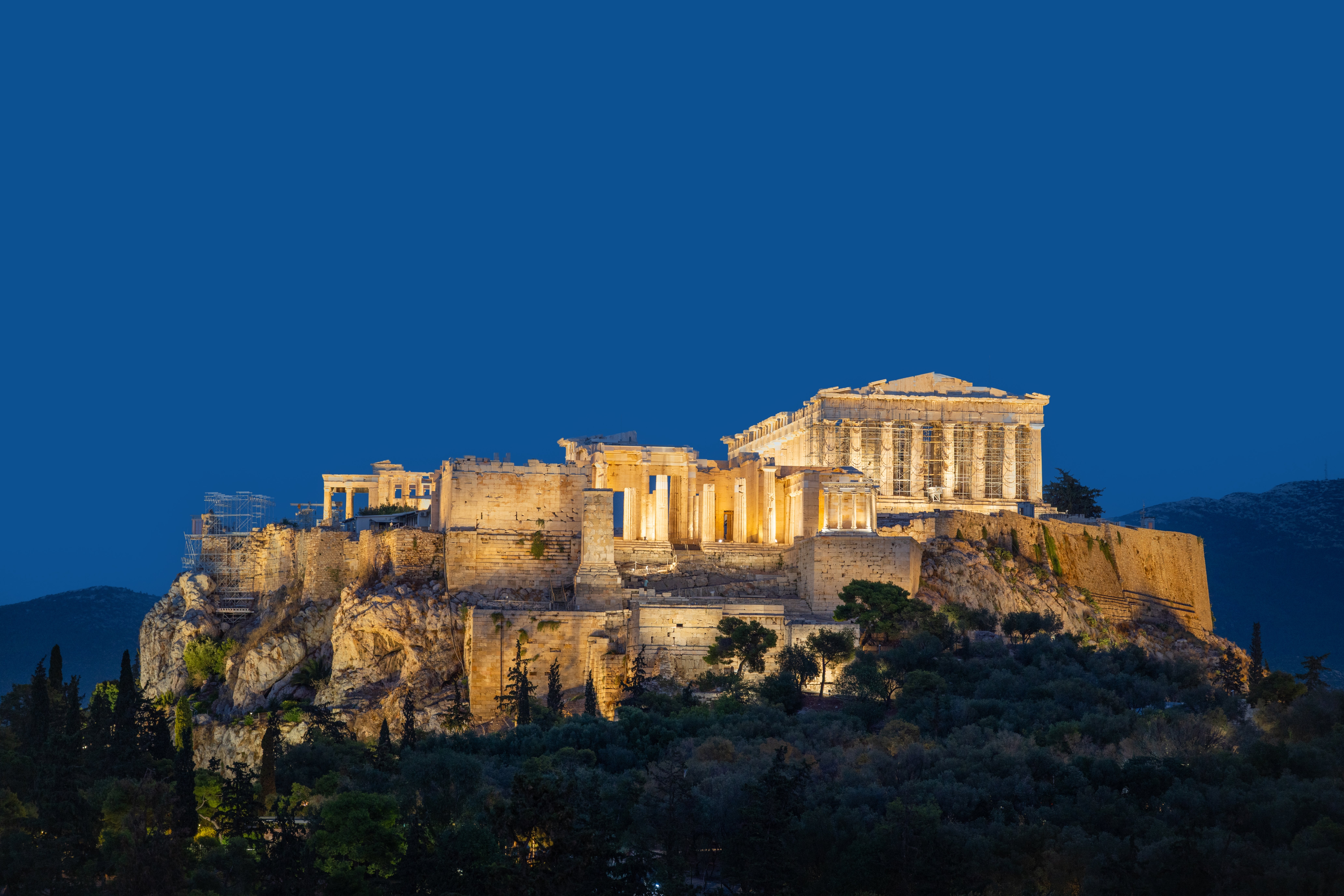 The Acropolis successful  Athens, Greece, illuminated astatine  night, showcasing past  structures atop a elevation  with a wide   entity  backdrop