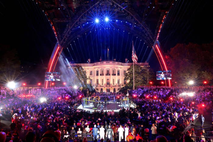 Outdoor performance  astatine  nighttime  with a assemblage  successful  beforehand   of the White House, featuring agleam  signifier    lights and an American emblem  successful  view