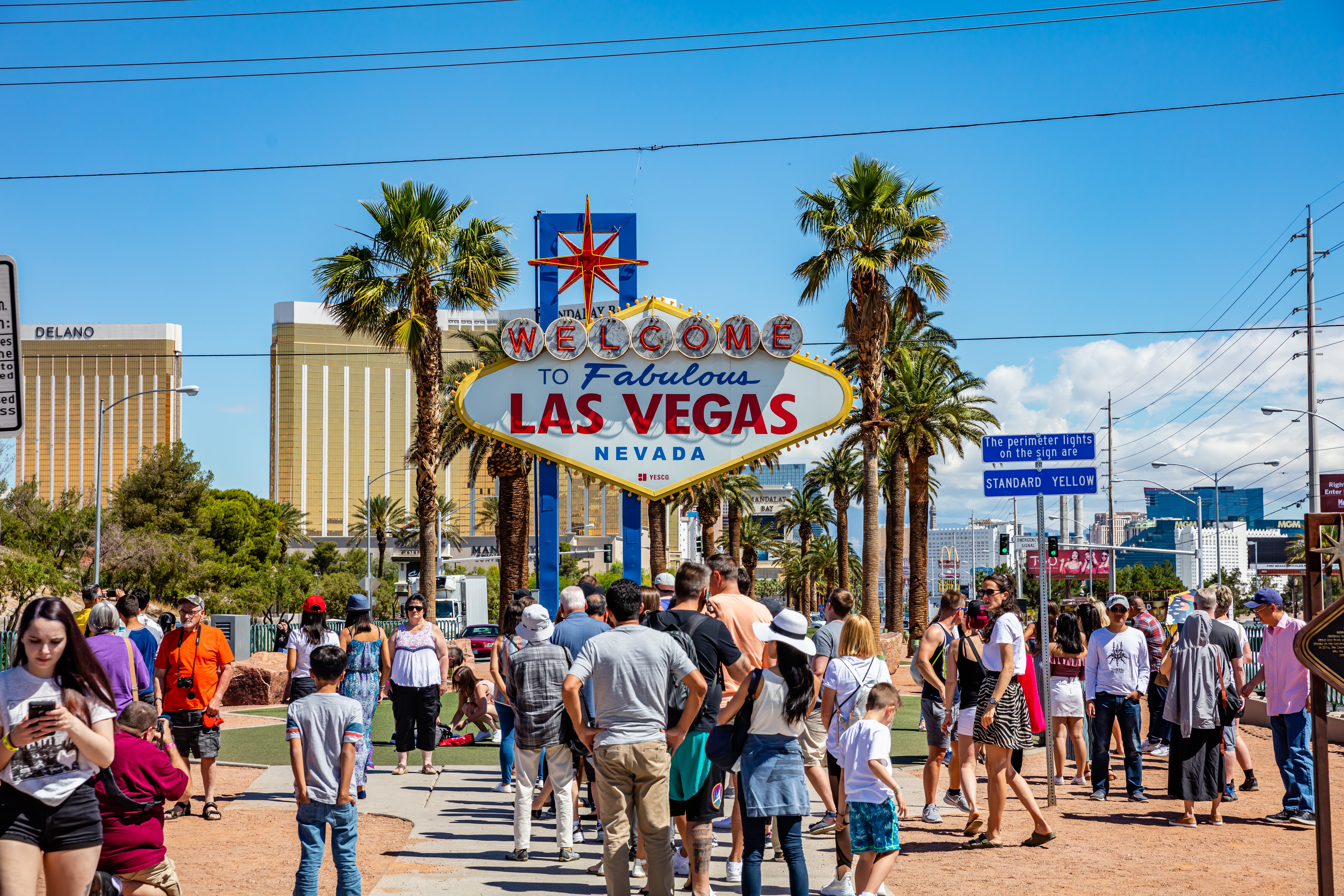 Crowd gathers astatine the "Welcome to Fabulous Las Vegas" sign, a fashionable tourer attraction with thenar trees and a casino skyline successful the background